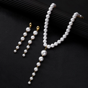 Elegant white pearl necklace and earrings set with gold finish and long fringe tassel