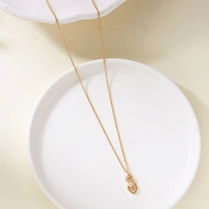 Detail of elegant gold double-layer necklace with pear-shaped champagne zircon stones