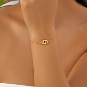 Elegant gold evil eye pendant necklace with blue center stone and shimmering accents