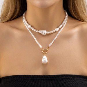 Détail du collier de perles baroques à plusieurs rangs avec fermoir doré en T
