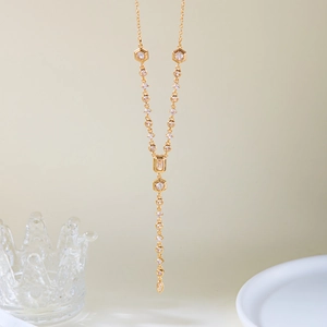 Detail of elegant gold-plated Y-necklace featuring clear zircon stones and drop pendant