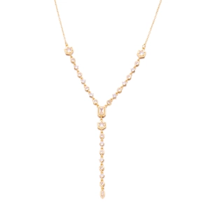 Detail of gold Y-shaped necklace with hexagonal and round zircon pendant on white background