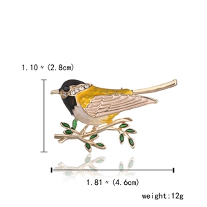 Detail view of bird brooch with enamel leaves and dimensions 4.6cm by 2.8cm