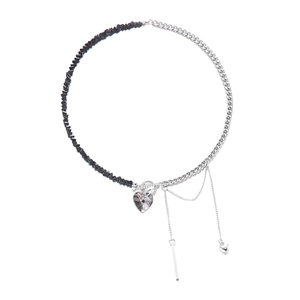Close-up of split design necklace with black beads and heart-shaped crystal pendant