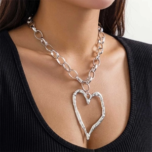 Detail of silver oversized irregular lava heart pendant on a chunky cable link chain