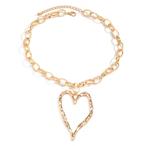 Detail of chunky gold chain necklace with a large textured lava heart pendant