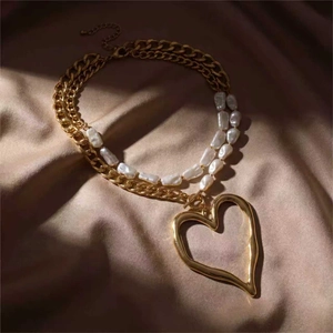 Double layer necklace with baroque pearls, gold chain and large lava heart pendant