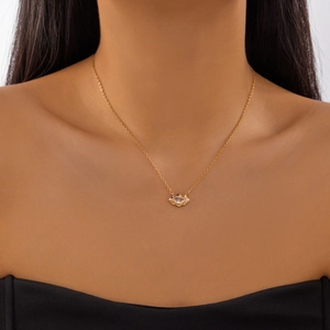 Golden eye shaped pendant necklace with marquise cut zircon worn as a clavicle chain