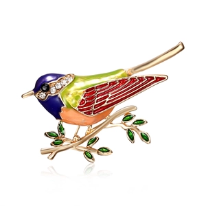 Macro detail of bird enamel brooch with colorful purple, green and red crystal accents