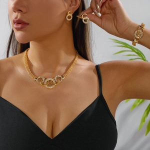 Detailed view of elegant gold jewelry set with intertwined pavé crystal rings