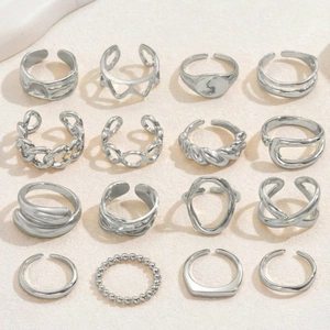 Flat lay detail of 16-piece silver ring set with butterfly and chain designs on stone