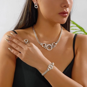 Detail of silver interconnected crystal rings on necklace, bracelet and ring set
