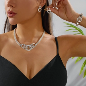 Sparkling silver jewelry set with intertwined rhinestone rings including necklace and earrings