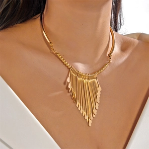 Detailed view of fashionable golden metal tassel necklace on a female model