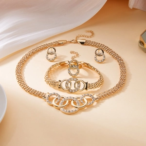 Elegant gold-plated jewelry set with crystal-encrusted interlocking rings and braided chain