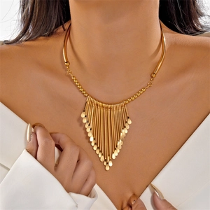 Close-up of gold irregular tassel necklace with water-drop charms on a female model