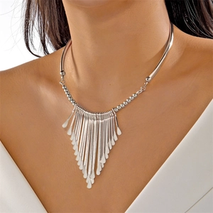 Detail view of silver fringe tassel necklace set featuring geometric teardrop pendants
