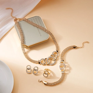 Golden 5-piece jewelry set with woven chains and rhinestone encrusted circular rings