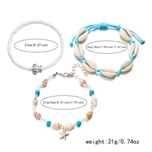 Detail of 3-piece bohemian anklet set with starfish shell pendants and turquoise beads