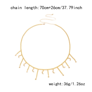 Detail of gold layered waist chain featuring celestial moon and star pendants with size specs