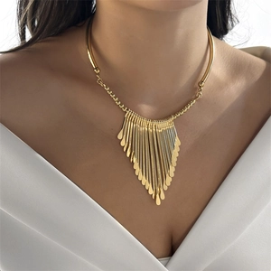 Close-up of gold fringe choker necklace featuring metallic bars and water-drop pendants