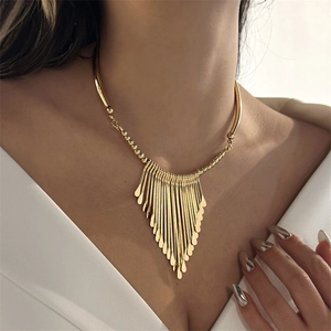 Detail of gold metal fringe choker with irregular flat tassels on a female model