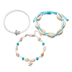 Detail of multi-layer ocean theme bracelet set with turtle, starfish and sea shell charms