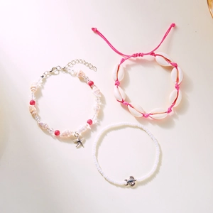 Detailed view of bohemian beach bracelet set with seashell, starfish and turtle charms