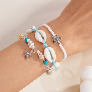 Close-up of Bohemian 3-piece bracelet set with starfish, turtle and seashell charms
