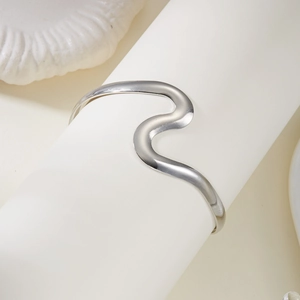 Vue détaillée du bracelet de bras double couche argenté ondulé sur support blanc