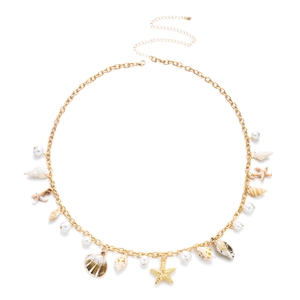 Detail of gold layered body chain featuring seashells, starfish pendants and pearls