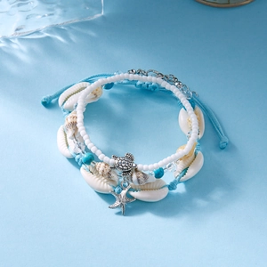 Detail of ocean-themed layered bracelet set with sea turtle and starfish charms