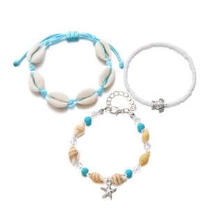 Three-piece bohemian beach jewelry set featuring seashell, starfish, and turtle charms