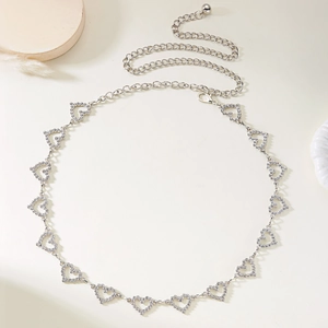 Close-up of silver heart-shaped waist chain with inlaid rhinestones and adjustable links