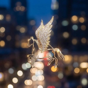 Detail of a luxury golden Pegasus brooch featuring sparkling wings with white zircon stones