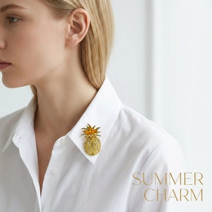 Detailed view of luxury crystal pineapple brooch on a white collared shirt
