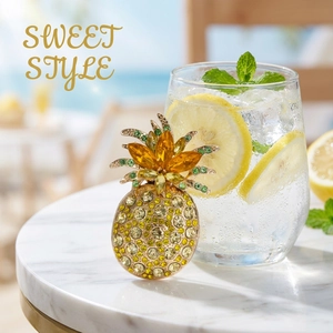 Detail of a luxury pineapple brooch with yellow and green crystals on a gold base