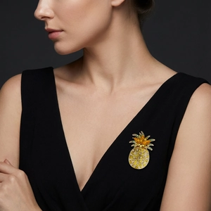 Elegant gold pineapple brooch with yellow and green crystals on black suit lapel