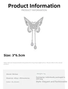 Detail view of silver hollow butterfly brooch with rhinestones and tassel chains