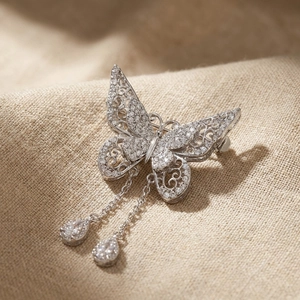 Exquisite hollow butterfly brooch with sparkling zircon inlays and elegant chain tassels