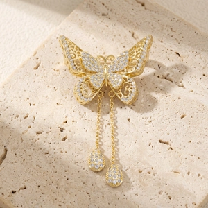 Elegant gold butterfly brooch with hollow filigree, white zircon stones and fringe tassels