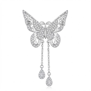 Detailed view of hollow butterfly brooch with tassels and sparkling white zircons