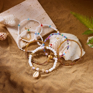 Detail view of Bohemian colorful bead bracelets with natural shells for beach vacation