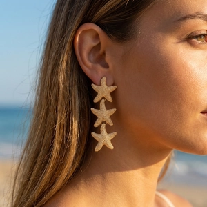 Exaggerated long gold starfish drop earrings featuring a matte metal finish for women