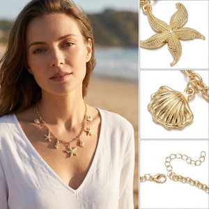 Detailed view of golden starfish and shell pendants with adjustable lobster clasp chain