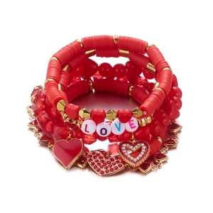 Detail van de 5-delige armbandenset met rode kralen en gouden LOVE-bedeltjes