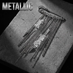Close-up of punk style silver brooch with multi-layer chains and metallic pendants