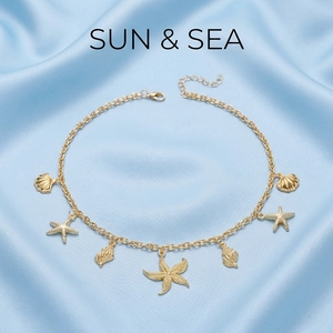 Detailed view of golden starfish and seashell pendants on a summer ocean style necklace