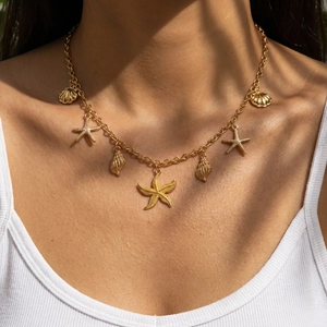 Golden starfish and seashell charm necklace for beach vacation with nautical pendants