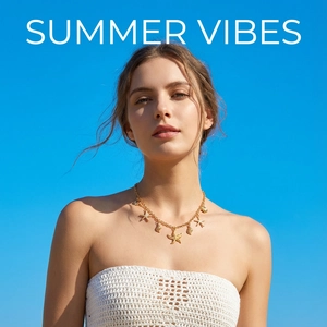 Golden starfish and seashell pendant necklace worn by a model against a clear blue sky